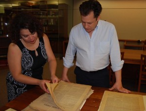 Curator, Marisol Ramos showing Strochlitz Travel Grant awardee Forest Hylton a Bolivian newspaper