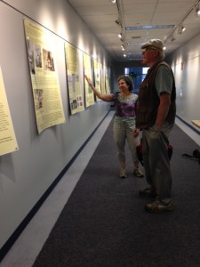 UConn Professor Ruth Glasser shows her exhibit Brass City/Grass Roots to UConn Libraries staff member Bill Miller, June 2015