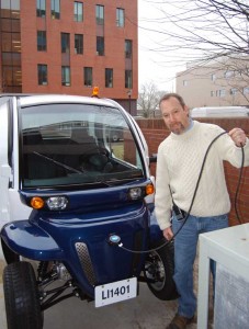 The Libraries' David Avery takes a moment to "fuel" the new vehicle in an outlet at the loading dock.